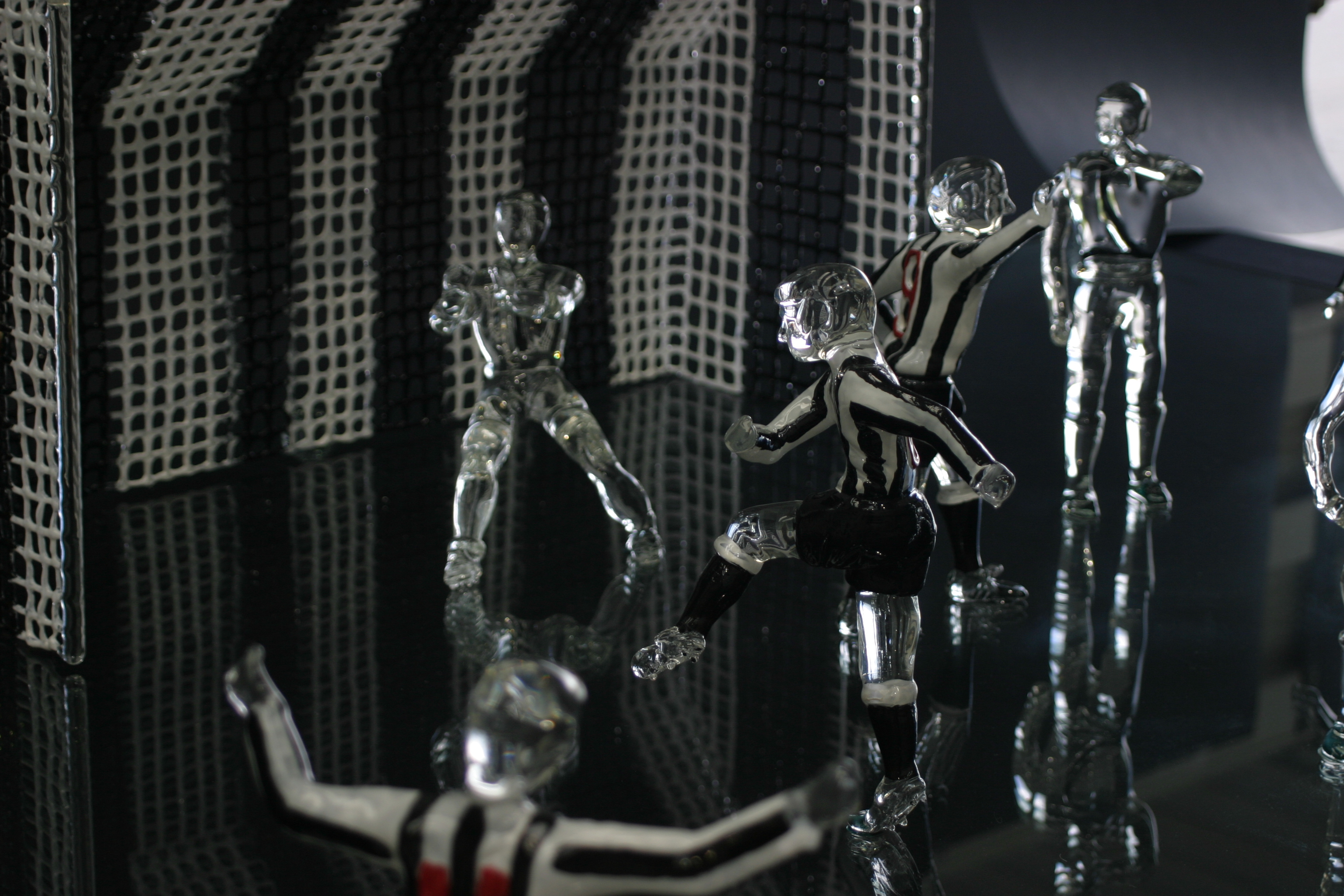 Glass football scene with goal and figures