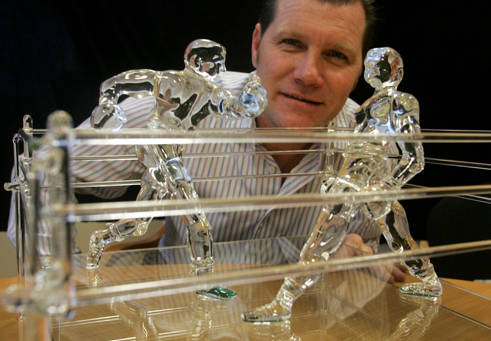 Glass boxing figures in a ring